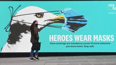 A sign in Melbourne encouraging people to wear masks as the city's residents entered a seven-day lockdown to curb the spread of Covid-19. AFP