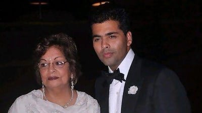 @caption; Karan Johar with his mother at his birthday party in Mumbai. IANS