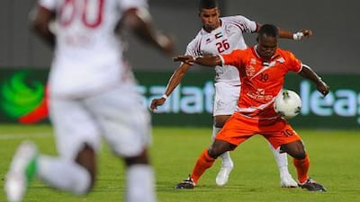 Al Wahda players, in white, did not have it easy against a resolute Ajman defence in Abu Dhabi on Thursday night.
