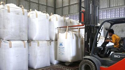 A worker uses a forklift to lift sacks of rice at a mill. Thailand is in battle to offload grain from around 18 million tonnes in national stocks after an audit noted that 70 per cent is deteriorating and another fifth is inedible. Chaiwat Subprasom / Reuters