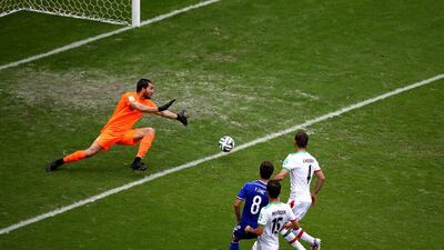Miralem Pjanic of Bosnia shoots and scores his team's second goal past goalkeeper Alireza Haghighi of Iran to make it 2-0 in their match on Wednesday at the 2014 World Cup. Michael Steele / Getty Images