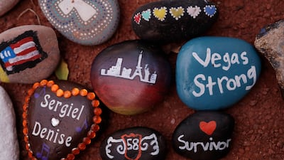 Stones are placed at a memorial during a healing garden dedication. EPA