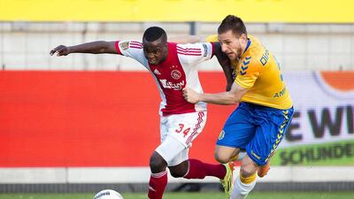Ajax Amsterdam's Lesly de Sa, left, in action against RKC Waalwijk's Remy Amieux, right, during their Dutch Eredivisie match on Wednesday. Joep Leenen / EPA / April 2, 2014