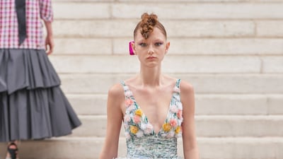 At Chanel, a tiered skirt was covered in feathers, while a halterneck top was decorated with lines of sequins and pom-poms.