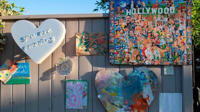 Works of art are displayed as part of artist Ann Morrow Johnson's "Museum of Quarantine on Quebec" on the fence of her home in Hollywood, California, USA. AFP