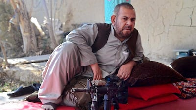 Afghan police commander Sultan Mohammed rests at a house in the Panjwai district of Kandahar province. A captured Taliban rifle at his side, commander Mohammed now controls what once a hornet’s nest of insurgents. Javed Tanveer / AFP