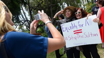 Supporters of women’s rights groups pose with a placard during the protest. Frederic J. Brown / AFP