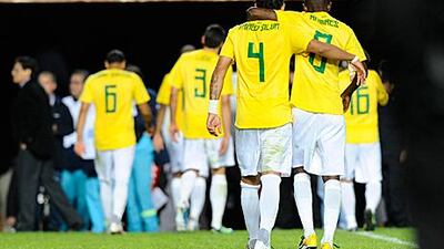 Brazil players trudge off the pitch dejected following their shoot-out defeat to Paraguay.