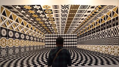 A man looks at a piece by the Italian artist Pedro Friedeberg during the first day of activities of Zona Maco contemporary art fair, in Mexico City. EPA
