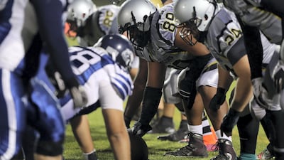 Dubai Barracudas and the Abu Dhabi Wildcats on the line of scrimmage during the Desert Bowl. Chris Whiteoak / The National