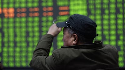 A stock investor sits in front of a display screen at a brokerage house in Hangzhou, China. The country's stock market has been the best performer of the year, with share prices up a third. EPA