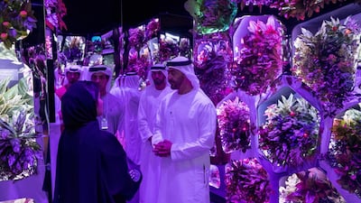 Sheikh Mohammed bin Zayed tours the Museum of the Future exhibit with Mohammed Mubarak Al Mazrouei, Undersecretary of the Crown Prince Court of Abu Dhabi, back centre, and other dignitaries. Hamad Al Kaabi / Crown Prince Court - Abu Dhabi