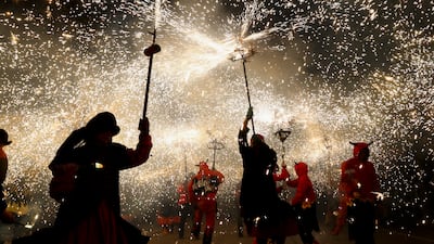 People take part in the traditional correfoc event, held within the Merce fiestas in Barcelona. Participants dress as demons and run through the streets as they light fireworks. EPA