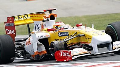 Renault's Spanish driver Fernando Alonso drives on three wheels at the Hungaroring racetrack after he lost one during the Hungarian Grand Prix on Sunday. The French team have been given a one race ban by race stewards for allowing their car to run in an unsafe fashion.