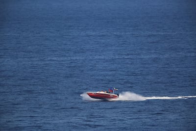 Members of the Iranian Revolutionary Guard aboard a speedboat shadow and watch the USS John C. Stennis aircraft carrier on Friday, Dec. 21, 2018. AP