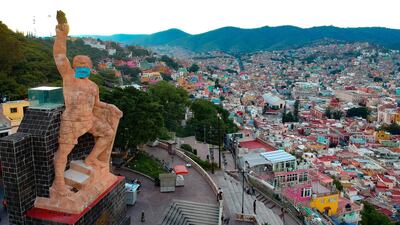 The monument to the Pipila, which is adorned with a giant mask to raise awareness during the coronavirus pandemic, in Guanajuato, Mexico. EPA