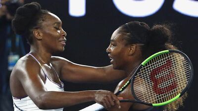 Serena Williams, right, hugged an evidently emotional Venus after winning her 23rd major title. Thomas Peter / Reuters