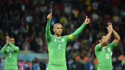 Algeria captain Madjid Bougherra, centre, and forward Abdelmoumene Djabou, right, acknowledge the crowd after their 2-1 loss to Germany at the 2014 World Cup on Monday night. Gabriel Bouys / AFP / June 30, 2014