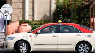 A Dubai Taxi Corporation red taxi at Ibn Battuta Mall. Drivers of the red taxis will be eligible to ask their employers for interest-free loans.