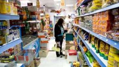 Customers at an Abu Dhabi grocery store. The ratio of gracery stores to hypermarkets has decreased.