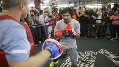 Manny Pacquiao trains with Freddie Roach on Wednesday to prepare to fight Floyd Mayweather in the 'fight of the century' on May 2. Jae C Hong / AP