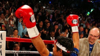 Manny Pacquiao signals to the crowd before facing Timothy Bradley during their welterweight fight on April 9, 2016 at MGM Grand Garden Arena in Las Vegas, Nevada. Christian Petersen/Getty Images/AFP