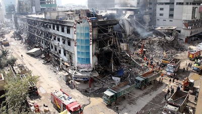 Rescuers search through the rubble at Gul Plaza after a deadly fire in Karachi, Pakistan. EPA
