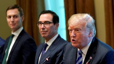 US President Donald Trump, seated with adviser Jared Kushner (L) and Treasury Secretary Steve Mnuchin. Reuters
