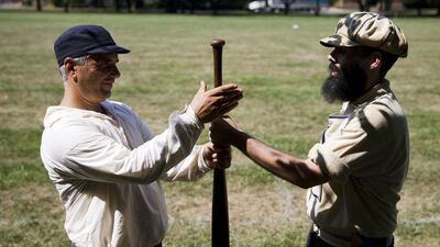Above, vintage baseball players Al "Rocky" Belbol, with the Brooklyn Eckfords of New York, left, and Jamie "Mouth" Ford, of the Athletic Base Ball Club of Philadelphia, try to get the upper hand to determine bating order during the 2014 Base-Ball Exhibition & Fair at the Navy Yard in Philadelphia. Matt Rourke / AP