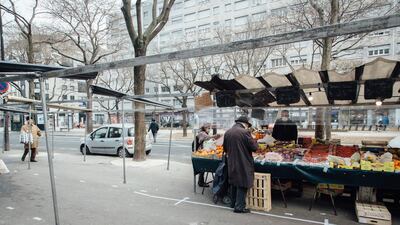 An elderly shopper wearing a protective face mask browses fruit and vegetables at a street market during coronavirus containment and movement restrictions in Paris, on March 20, 2020. Bloomberg