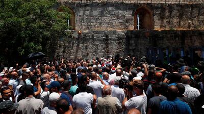 Palestinian Muslims, who refuse to enter due to new security measures including metal detectors and cameras, speak to the press outside the Lion's Gate, a main entrance to Al-Aqsa mosque compound, in Jerusalem's Old City, after security forces reopened the ultra-sensitive site. Israel took the highly unusual decision to close the Al-Aqsa mosque compound for Friday prayers, leading to anger from Muslims and Jordan, the holy site's custodian. It remained closed on July 15, while parts of Jerusalem's Old City were also under lockdown. AFP