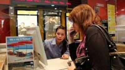 Aya Yasser, 16, purchases a ticket to see The Twilight Saga: New Moon, at Marina Mall in Abu Dhabi. As the board at rear attests, many showings were sold out.