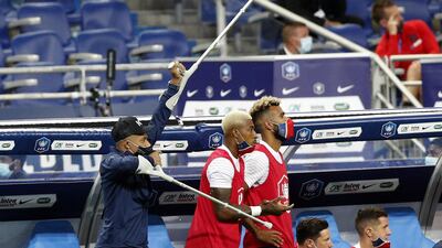 Kylian Mbappe celebrates on crutches. EPA