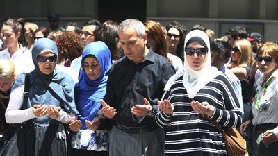 Sydney Muslim community leader Jamal Rifi, centre, and his family members pray at a makeshift memorial after the siege in Sydney. Steve Christo / AP Photo