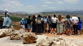 Israelis look across the northern border into southern Lebanon on Monday. AFP