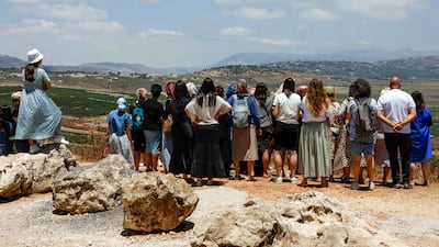 Israelis look across the northern border into southern Lebanon on Monday. AFP