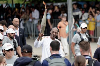 US rapper Snoop Dogg holds the torch as part of the 2024 Paris Olympic Games. Getty Images
