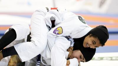 Wadima Al Yafei from Al Ain Jiu-Jitsu Club and Mona Al Balooshi from Al Wahda Club compete in the Jiu-Jitsu President’s Cup in Dubai. The sport has become hugely popular in the UAE, particularly among young Emiratis. Pawan Singh / The National