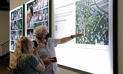 Visitors to the Wimbledon tournament look at All England Lawn Tennis Club proposals for the expansion of the site. Getty Images