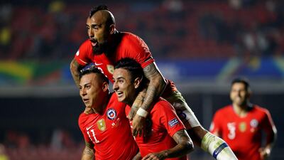 Erick Pulgar, right, of Chile celebrates with teammates Arturo Vidal and Eduardo Vargas. EPA