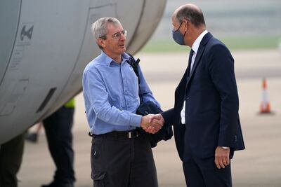 Britain's ambassador to Afghanistan, Laurie Bristow, left, is greeted by Philip Barton, permanent under-secretary of the Foreign, Commonwealth and Development Office, after disembarking a Royal Air Force Voyager at RAF Brize Norton last month, as the troops return from assisting with the evacuation of people from Kabul airport in Afghanistan. AFP