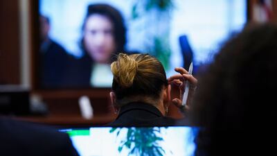 Depp reacts as Pennington testifies. AFP