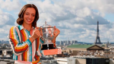 Poland's Iga Swiatek poses with the trophy Suzanne Lenglen near the Eiffel Tower in Paris. AFP