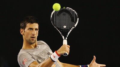 Novak Djokovic hits a backhand volley during a practice session on Thursday ahead of the Australian Open. Michael Dodge / Getty Images