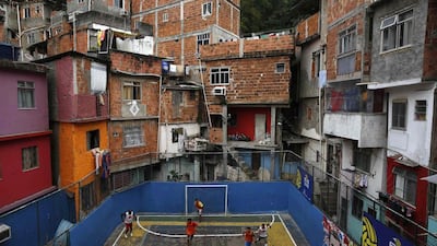 People take part in a football match held at the Tavares Bastos slum in Rio de Janeiro. The World Cup will be held in 12 cities in Brazil from June 12 till July 13. Pilar Olivares / Reuters