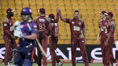 Rayad Emrit, centre, of Northern Warriors celebrates after taking the wicket of Tom Moores. Pawan Singh / The National
