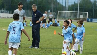 Manuel Pellegrini, the Manchester City manager, took time during the international break to attend a youth clinic at Abu Dhabi on Sunday. Delores Johnson / The National