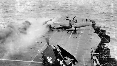 Damaged aircraft on the flight deck of the 'USS Saratoga' after direct hits by Japanese bombs off Iwo Jima during the Second World War. Getty Images