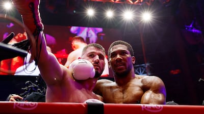 Anthony Joshua embraces Kristian Prenga after winning the fight. Reuters