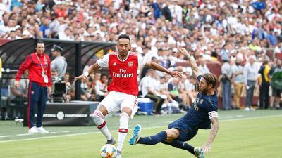 Arsenal forward Pierre-Emerick Aubameyang dribbles the ball past Real Madrid defender Sergio Ramos. Reuters